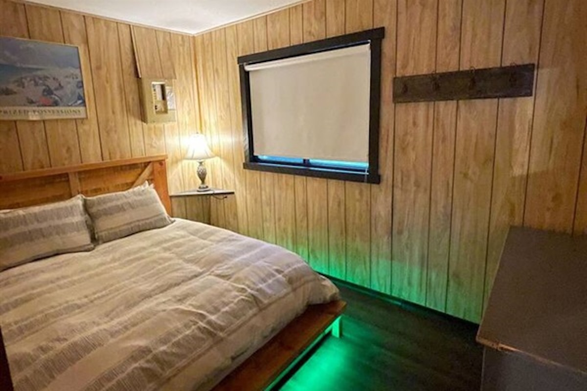 Comfortable bedroom with bedside lighting and accent glow
