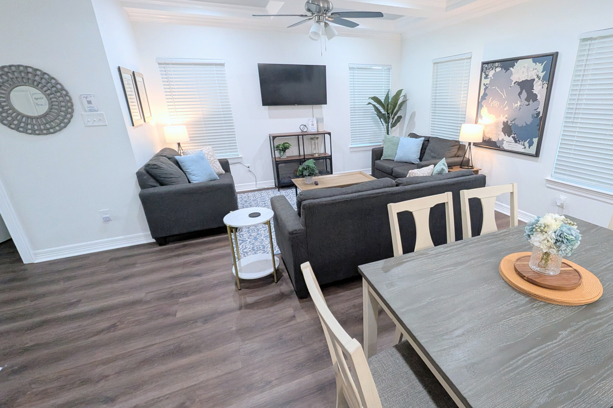 The dining area is directly behind the living room and offers additional spaces for your group to gather together. 