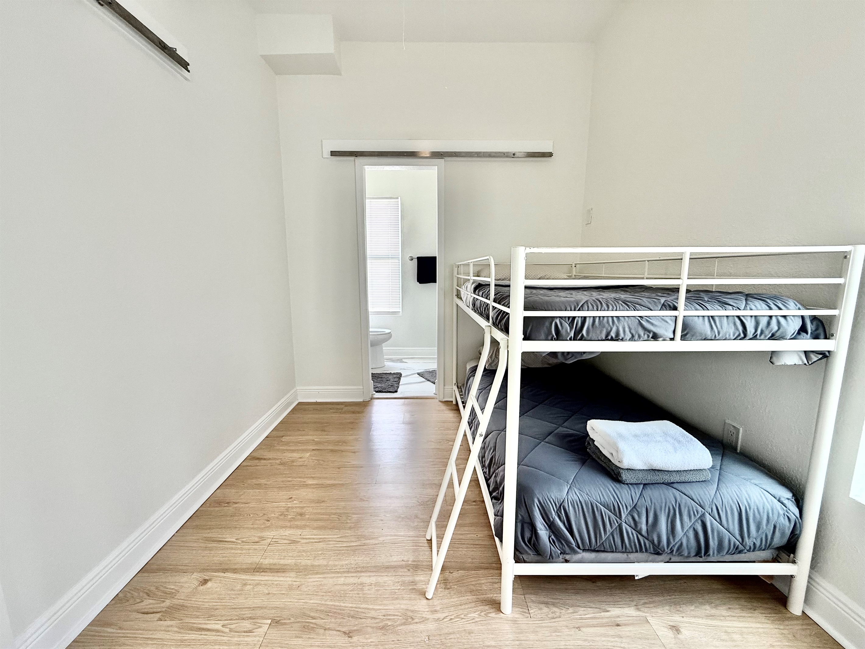 Fun and functional, this bunk room is ideal for kids or teens—complete with natural light and easy access to a modern bathroom.