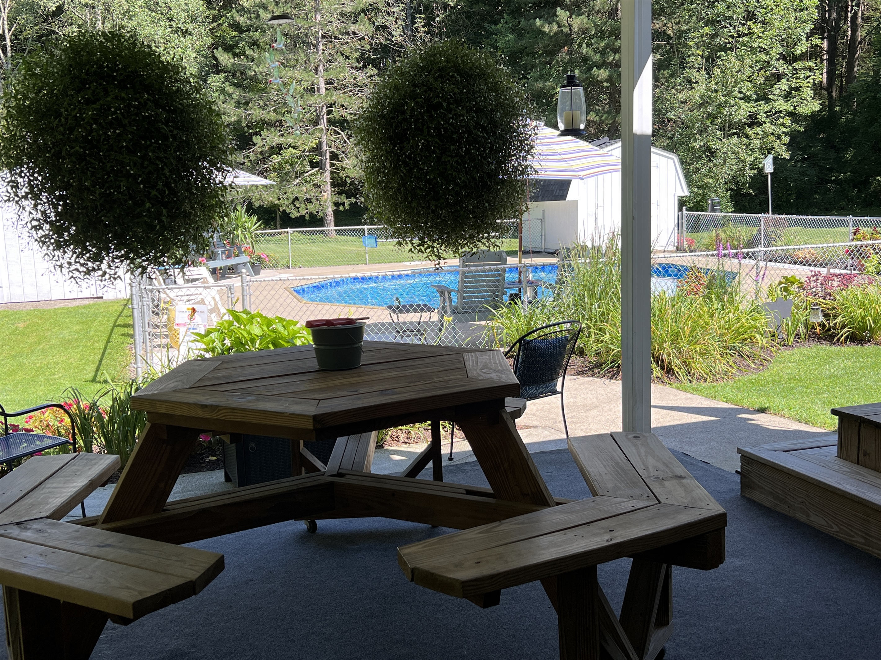 Outdoor room overlooking gardens and pool