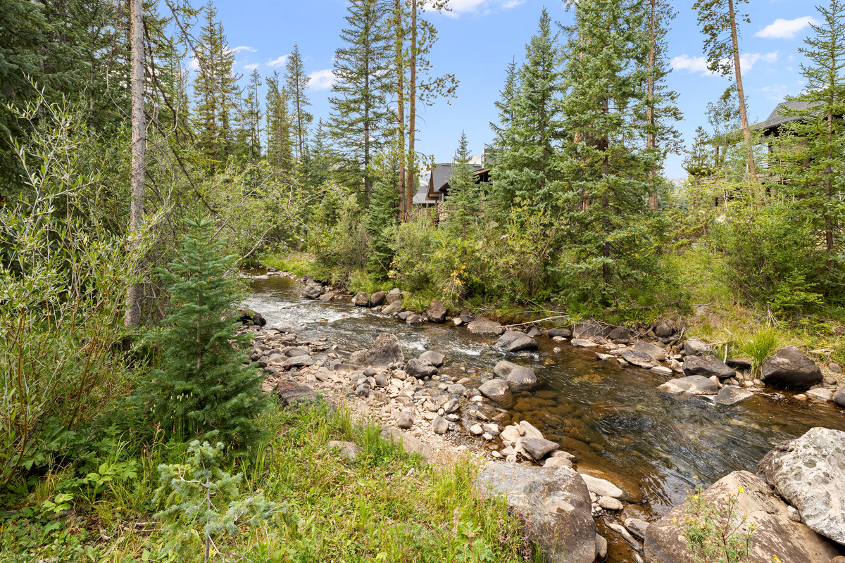 This photo of the Blue River was taken August 2026 during a severe drought. The river is running very low but still flowing, still beautiful, serene and scenic with private steps down to the edge of the river from the outdoor living area. 