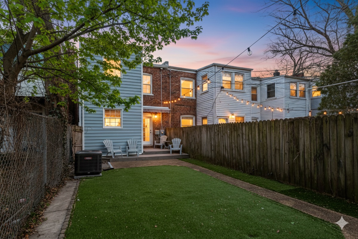 Charming Outdoor Retreat: Enjoy gatherings under string lights in this expansive backyard oasis!