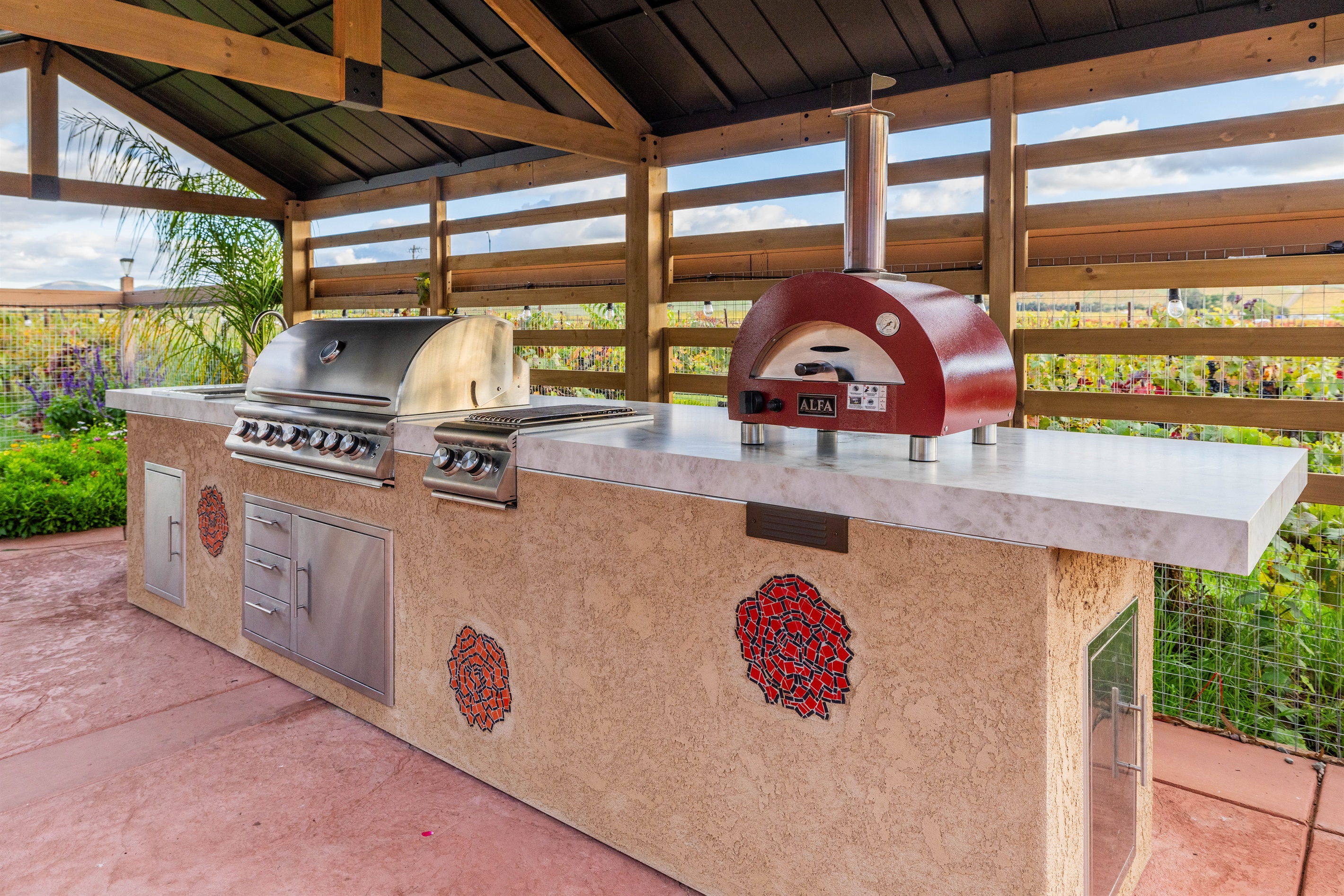 Our new outdoor kitchen, including covered BBQ, sink, and pizza oven.