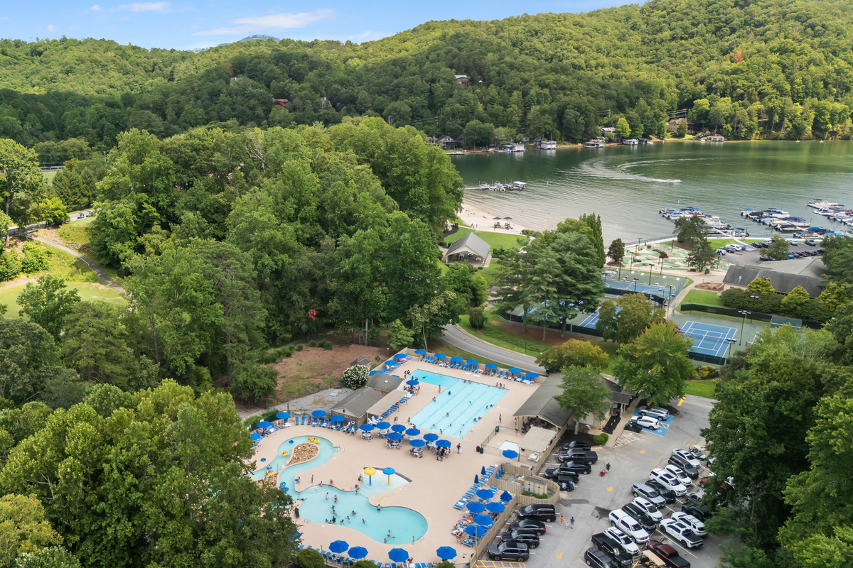 Birds eye view of the pools, courts, and lake.
