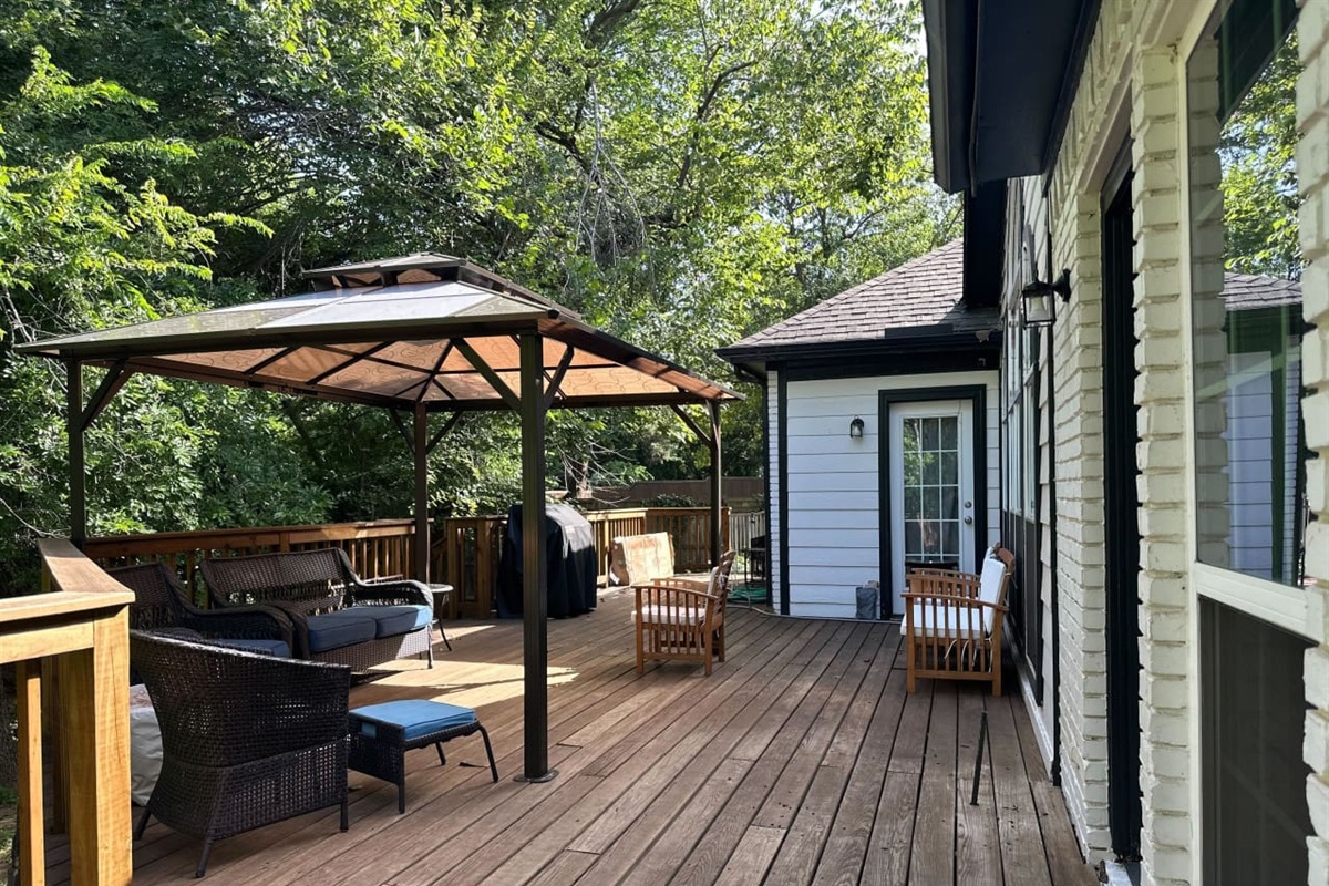Covered patio with grill for outdoor dining and entertaining.