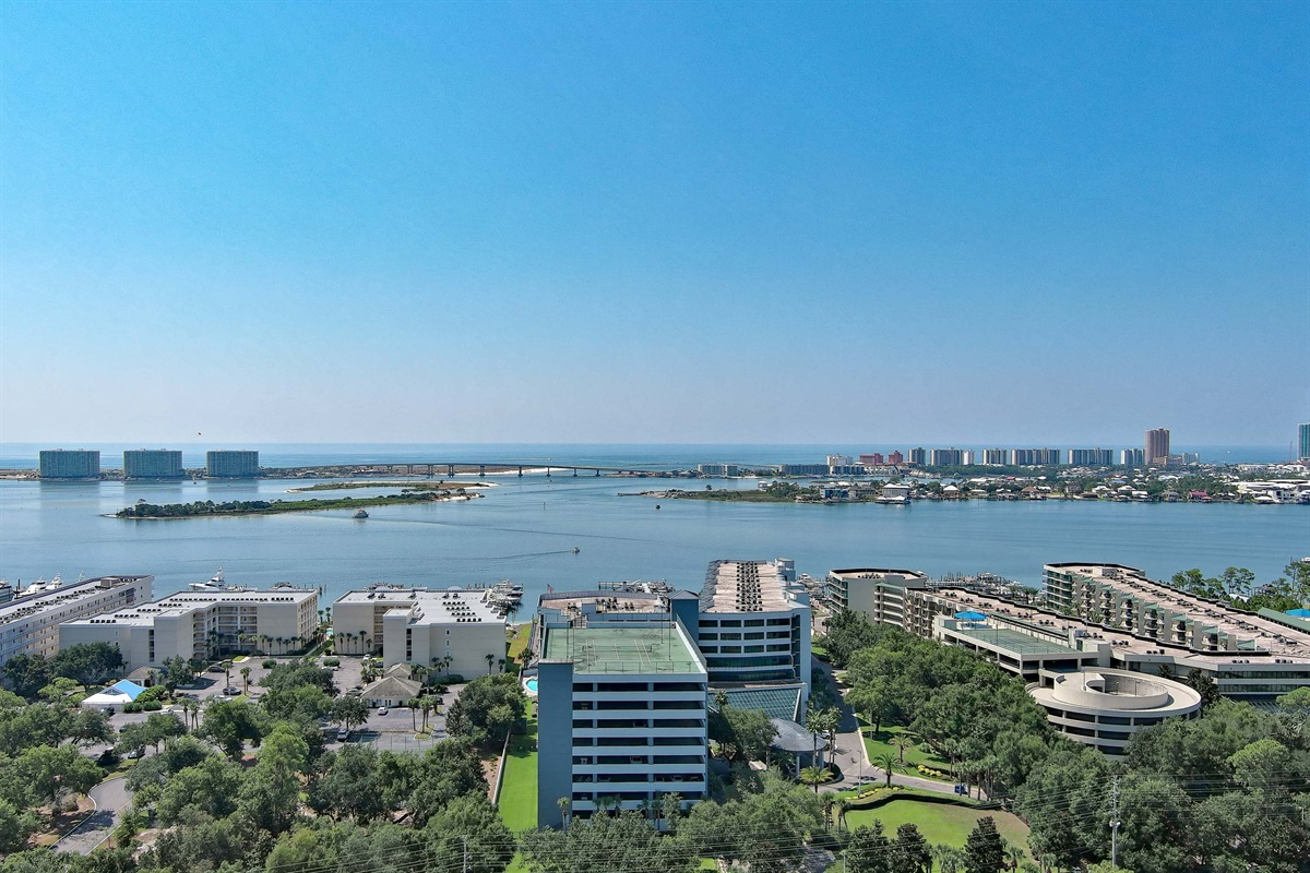 A breathtaking view of the coast, where the city skyline meets the endless horizon. This panoramic shot showcases the natural beauty of the bay alongside a dynamic urban landscape.