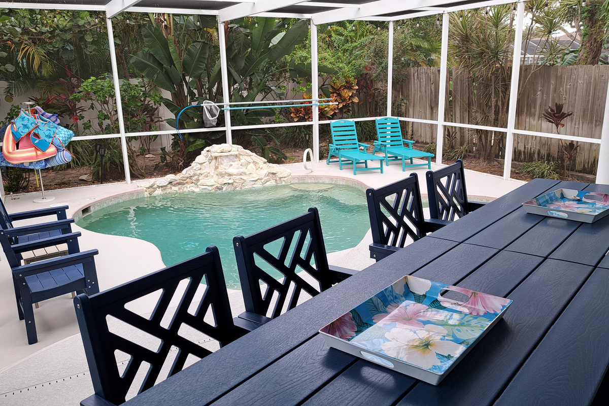 Settle in for outdoor dining with the pool and waterfall right there.