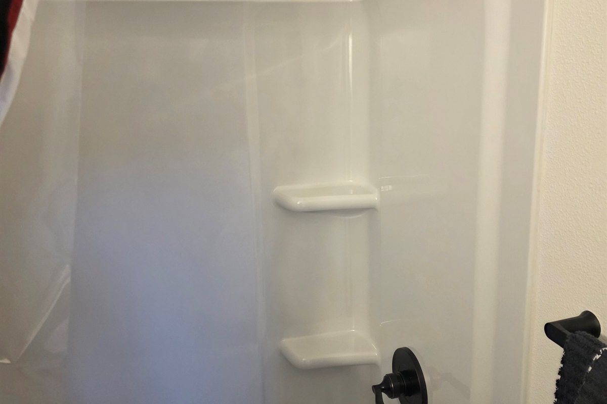 Bathroom includes a vanity, toilet, and shower/tub combo.