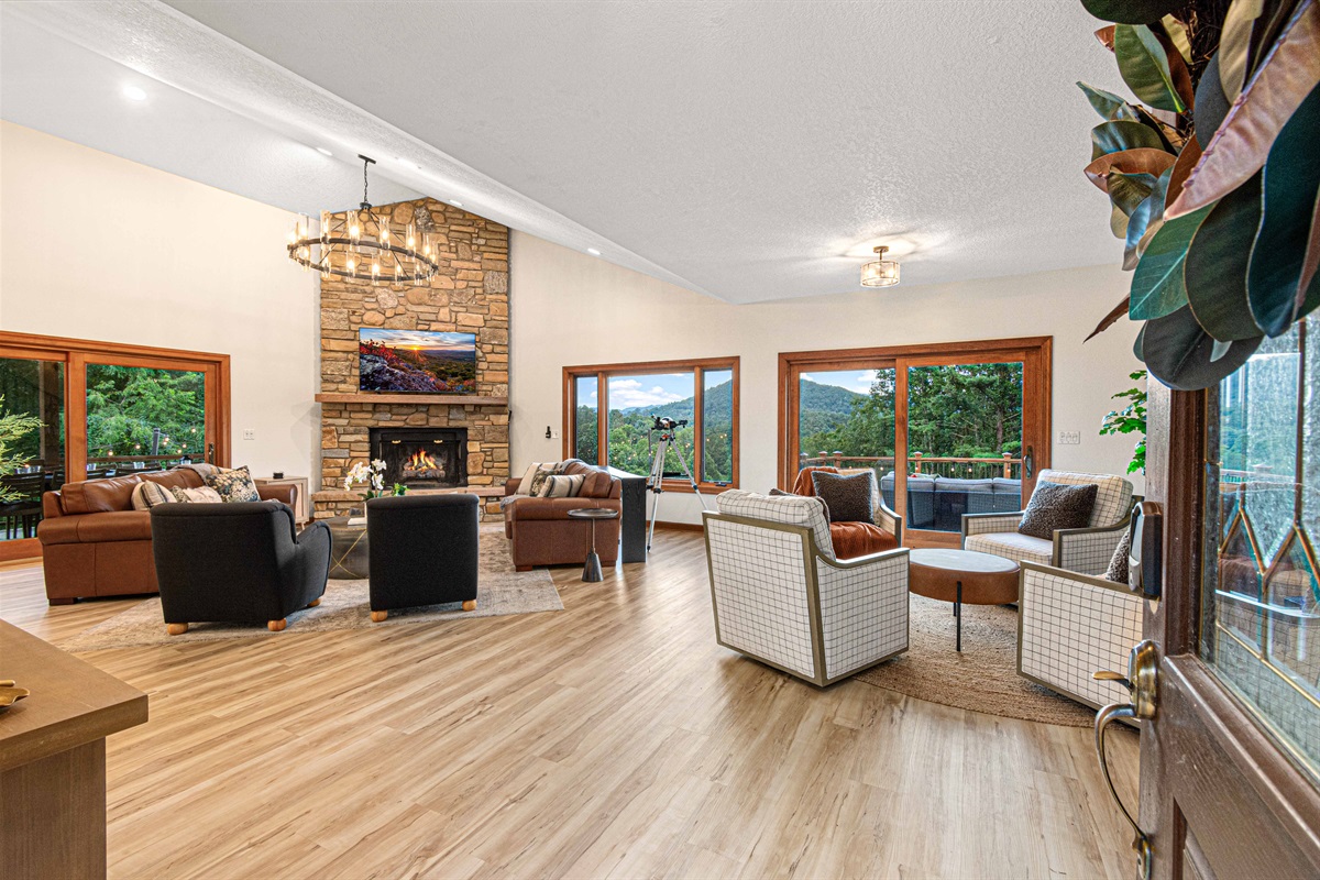Step into the heart of the lodge—spacious gathering areas with a stone fireplace, plush seating, and sweeping mountain views through every window. 🔥⛰️✨