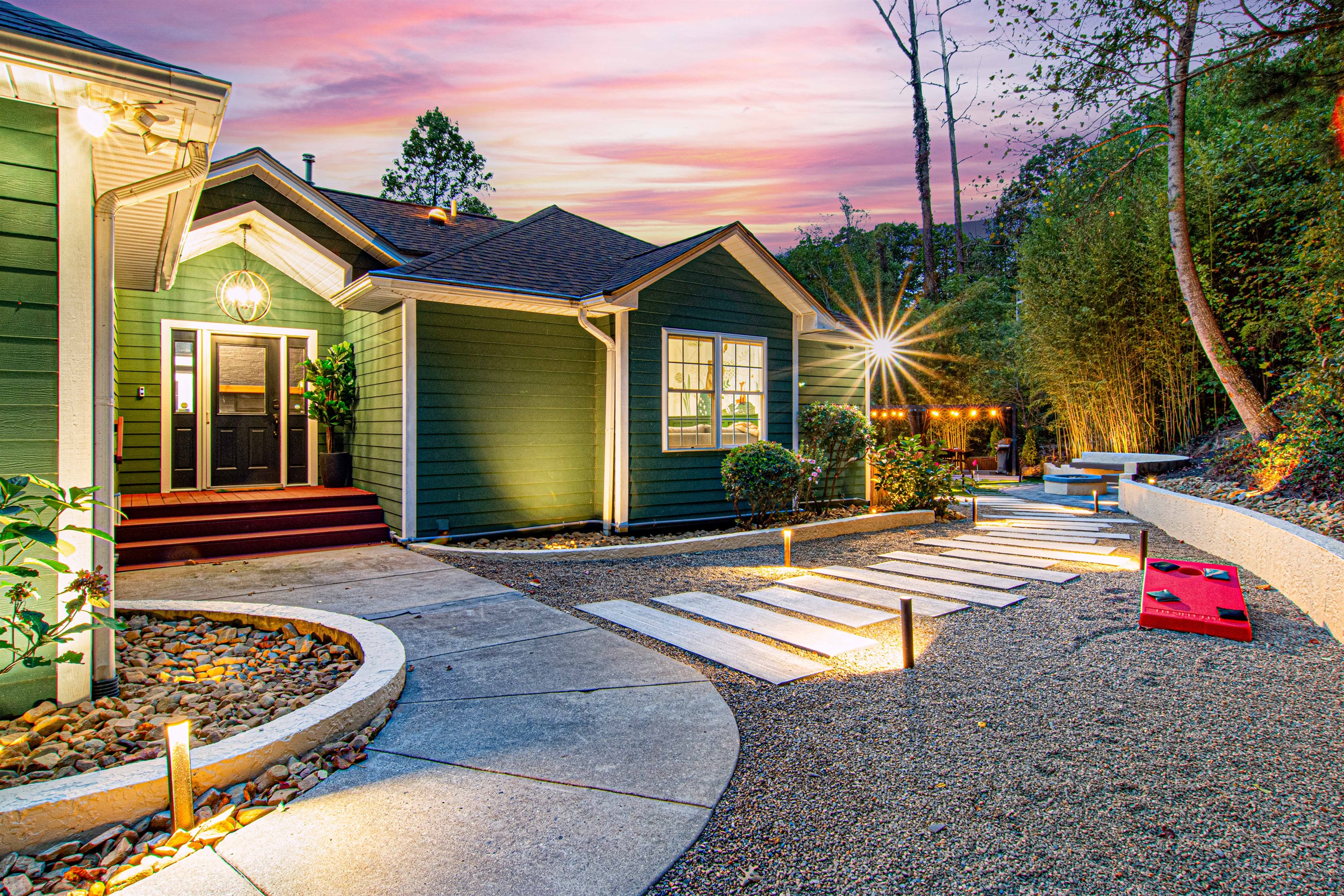 Welcome to your mountain getaway! 🌲✨ Stroll down the charming walkway to discover outdoor amenities, including a cozy fire pit, mini-putt, and a fun game of cornhole waiting for you in the backyard. Perfect for relaxing and making memories!