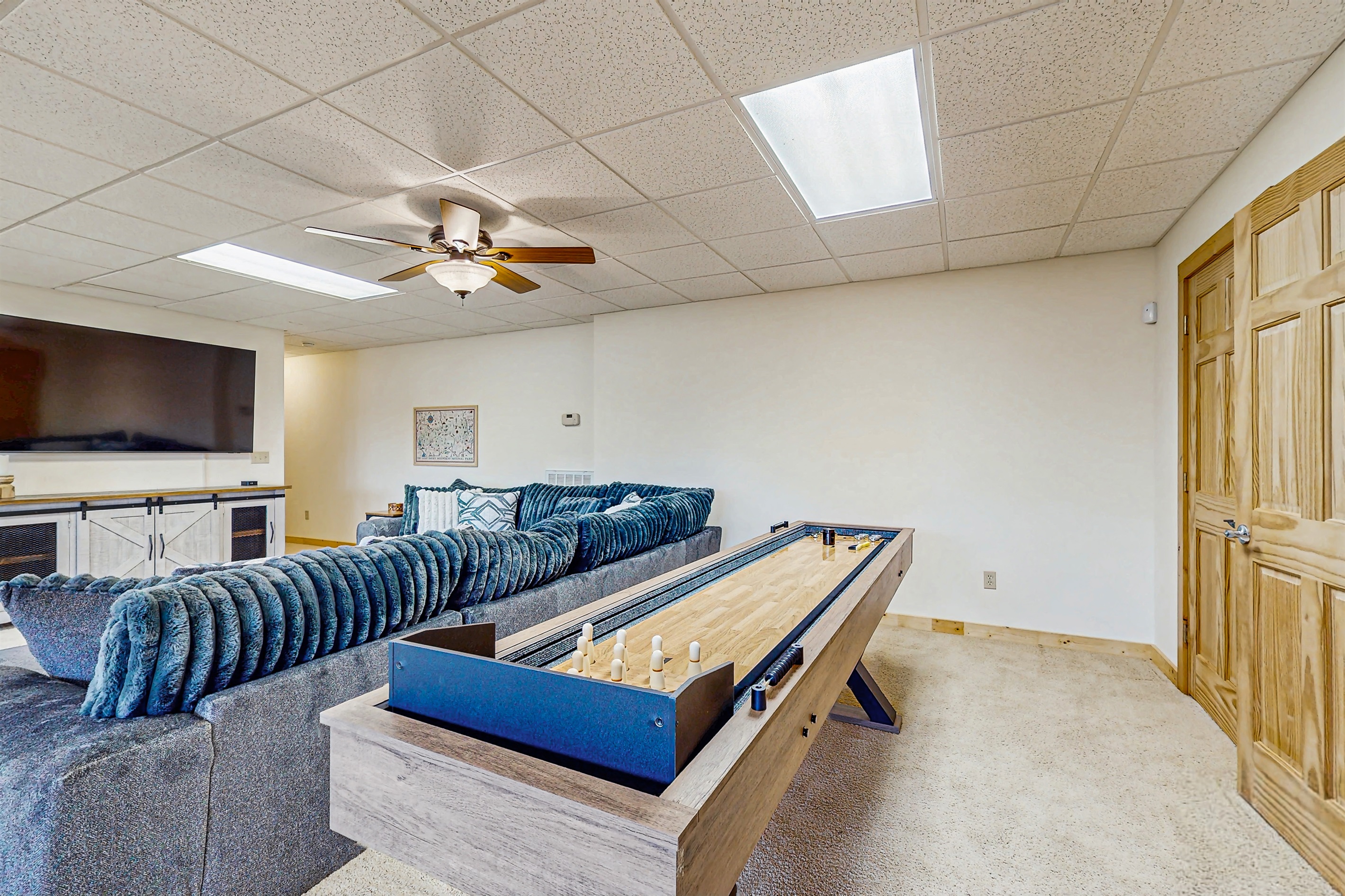 Large gathering space with game (foosball, Pool and shuffleboard) cozy couch and big screen TV