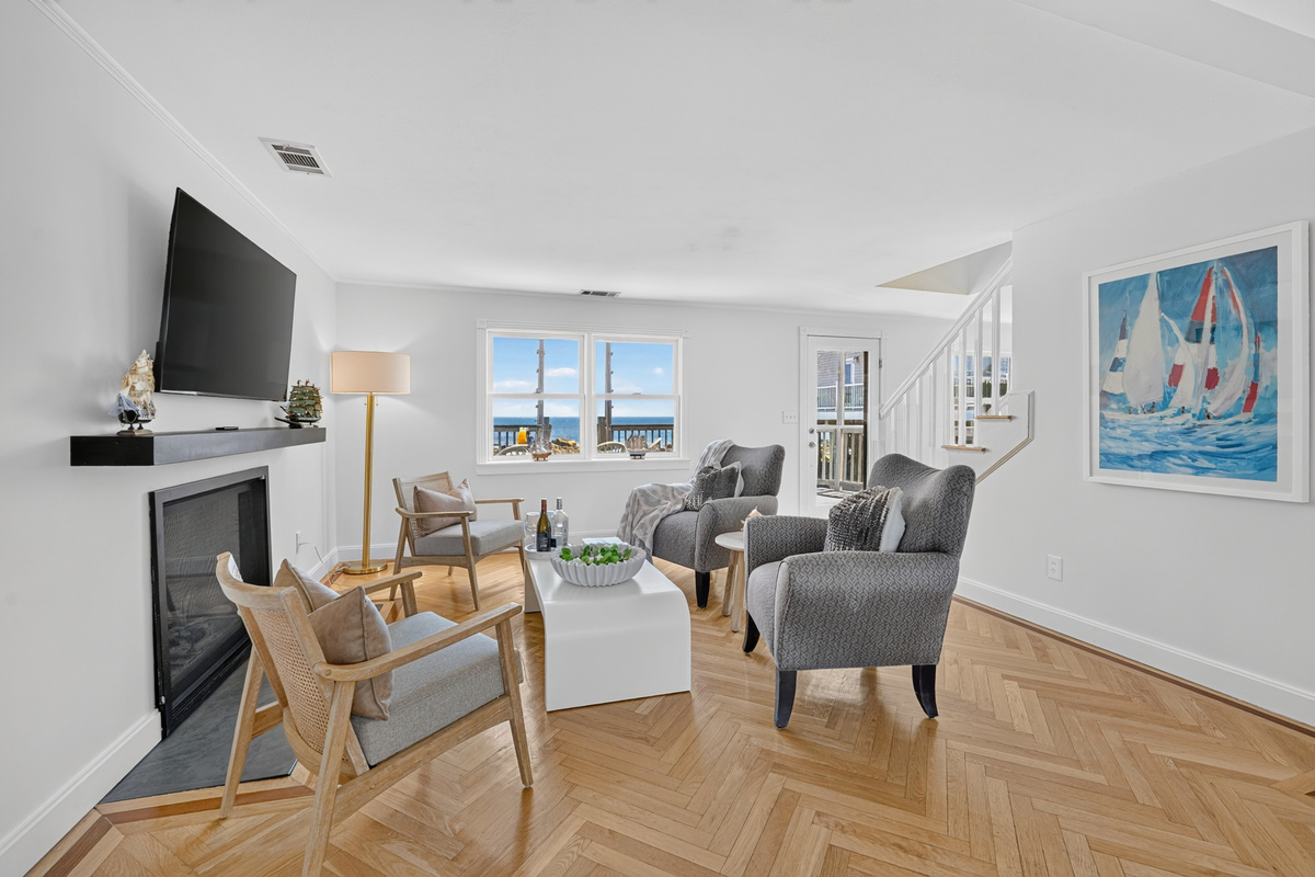 Open living and dining area with stylish coastal décor, abundant natural light, and incredible ocean views.