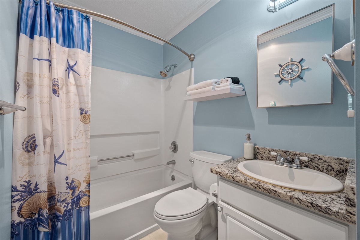 Shower and tub combo perfect for rinsing off after a long day at the beach