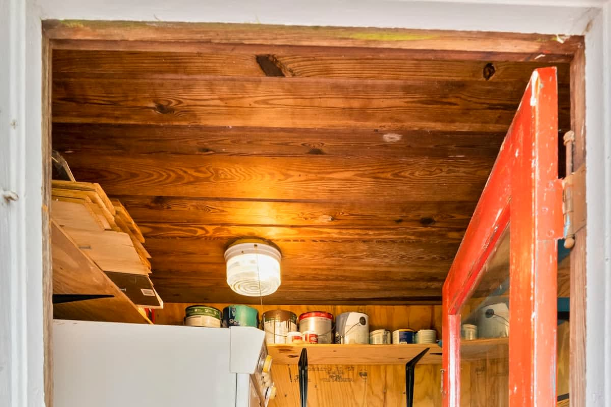 Behind the red door at the foot of the stairs is the laundry shed, with a stacked washer and dryer inside. It is shared with the downstairs cottage, which after a week of wet beach towels you will be very glad of.
