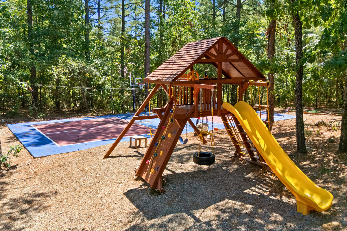 Younger guests have their own place to play with a wooded playset featuring swings, a slide, and plenty of room to enjoy the outdoors.