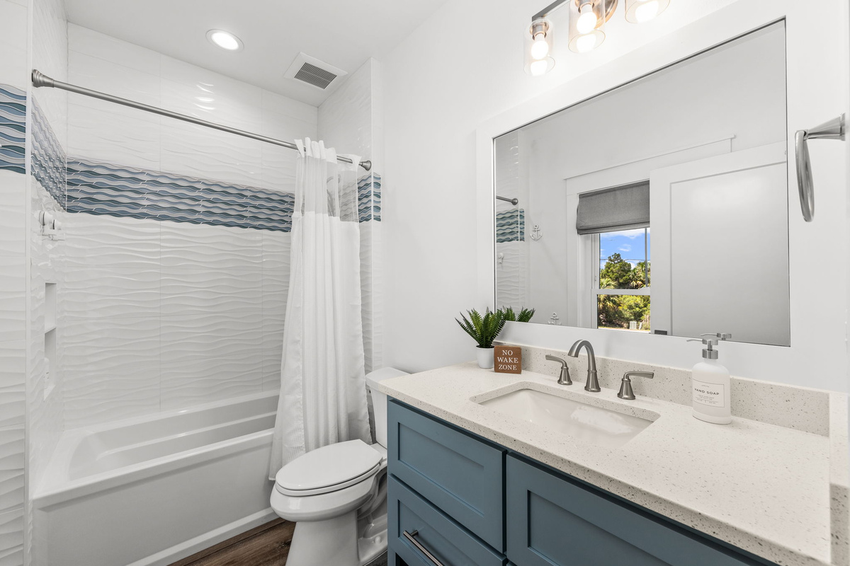 A bright, spacious bathroom attached to the bunk room makes getting everyone ready for beach adventures quick and easy.