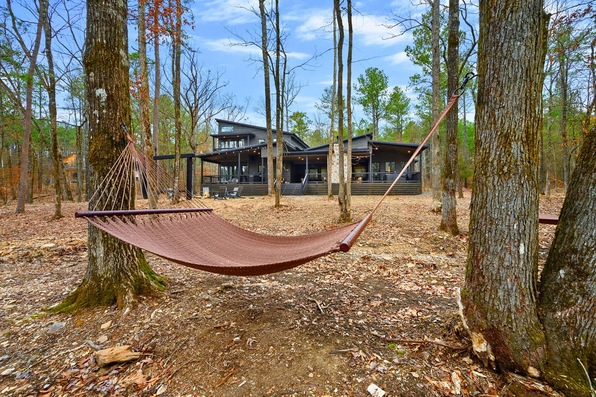 A hammock waits between the trees, giving you the perfect place to sway gently and relax outdoors.