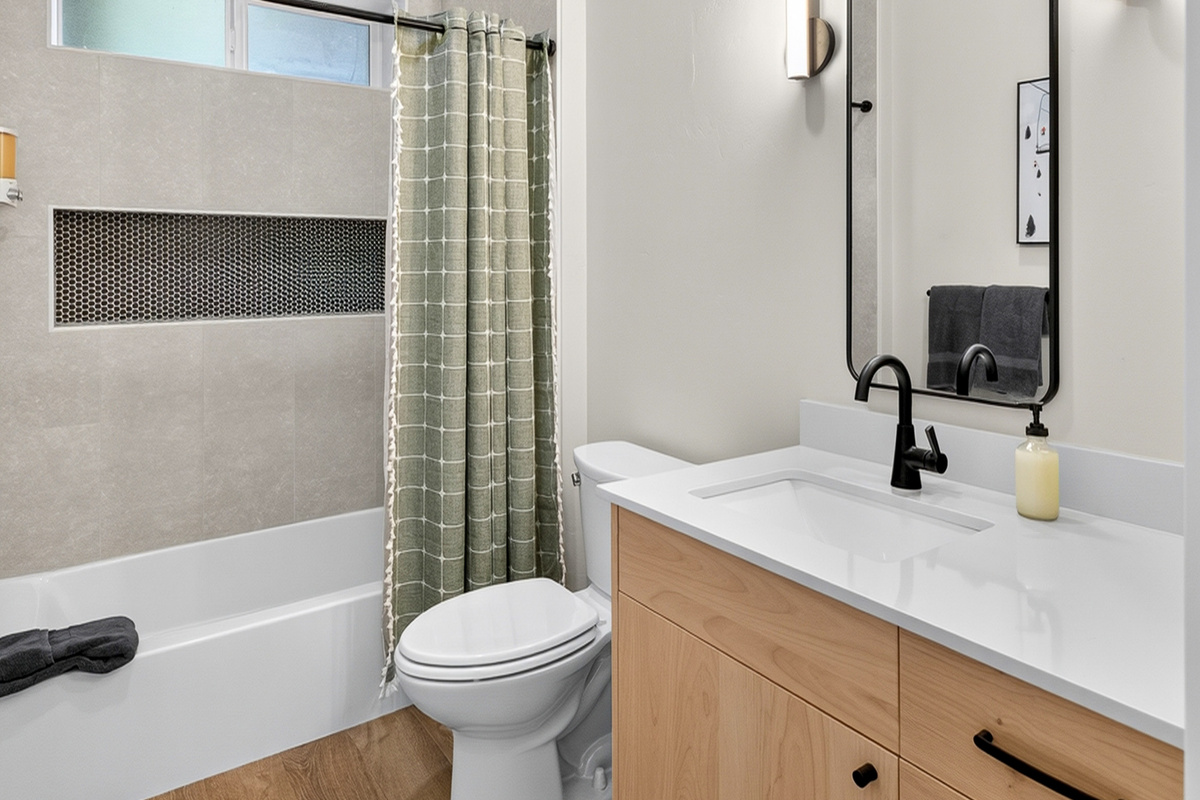 This elegant full bathroom with bathtub separates the two downstairs bedrooms.