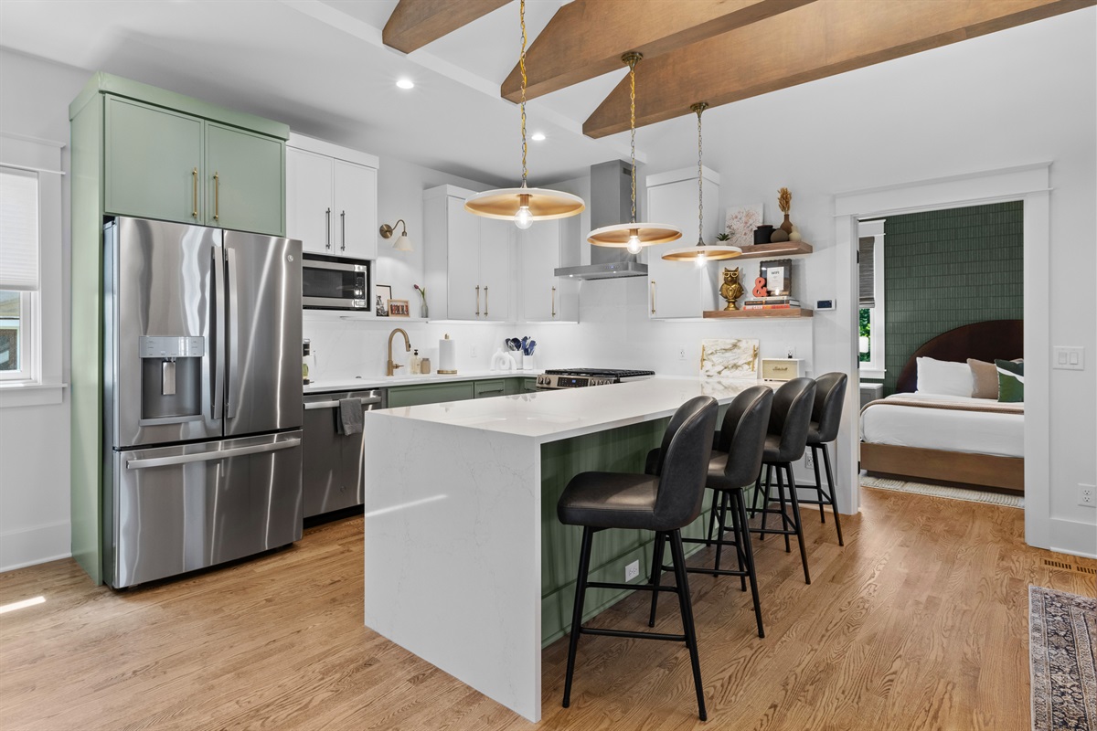 Chef’s kitchen with waterfall countertop and seating for four.