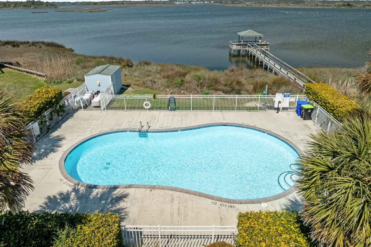 Community pool overlooking the water with private pier access