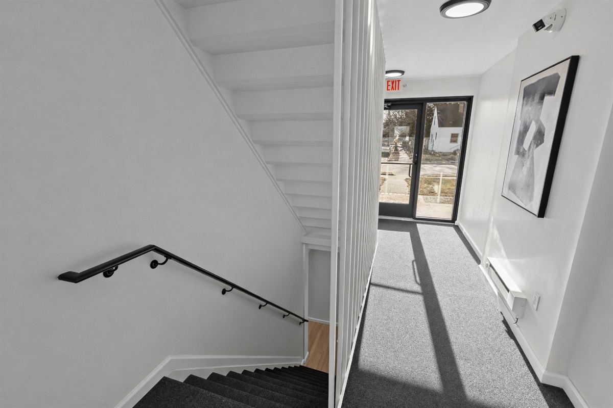 Well-lit common entry and stairwell with clean lines and modern lighting—secure, easy access, and a well-maintained shared space.