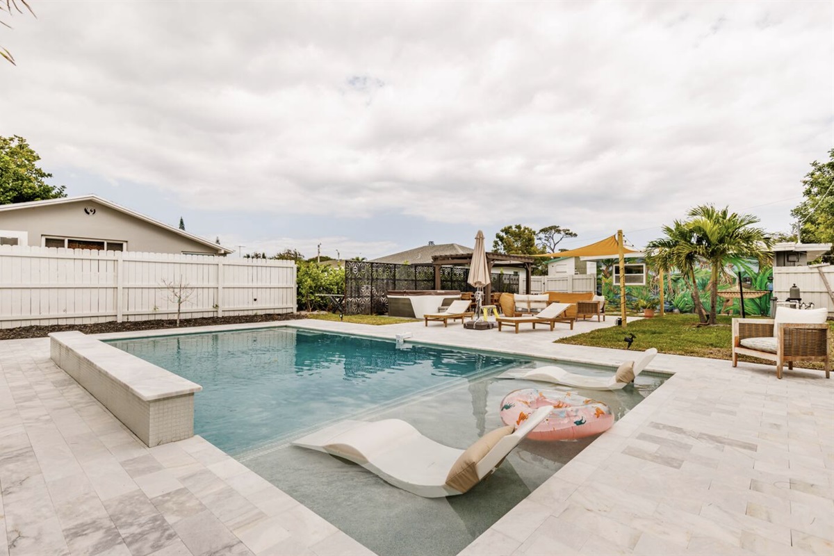 Completed in 2023, our oversized luxury pool comes with fountains, a waterfall and a unique, custom tropical mural on the back of the house. Enjoy this sliver of backyard paradise!