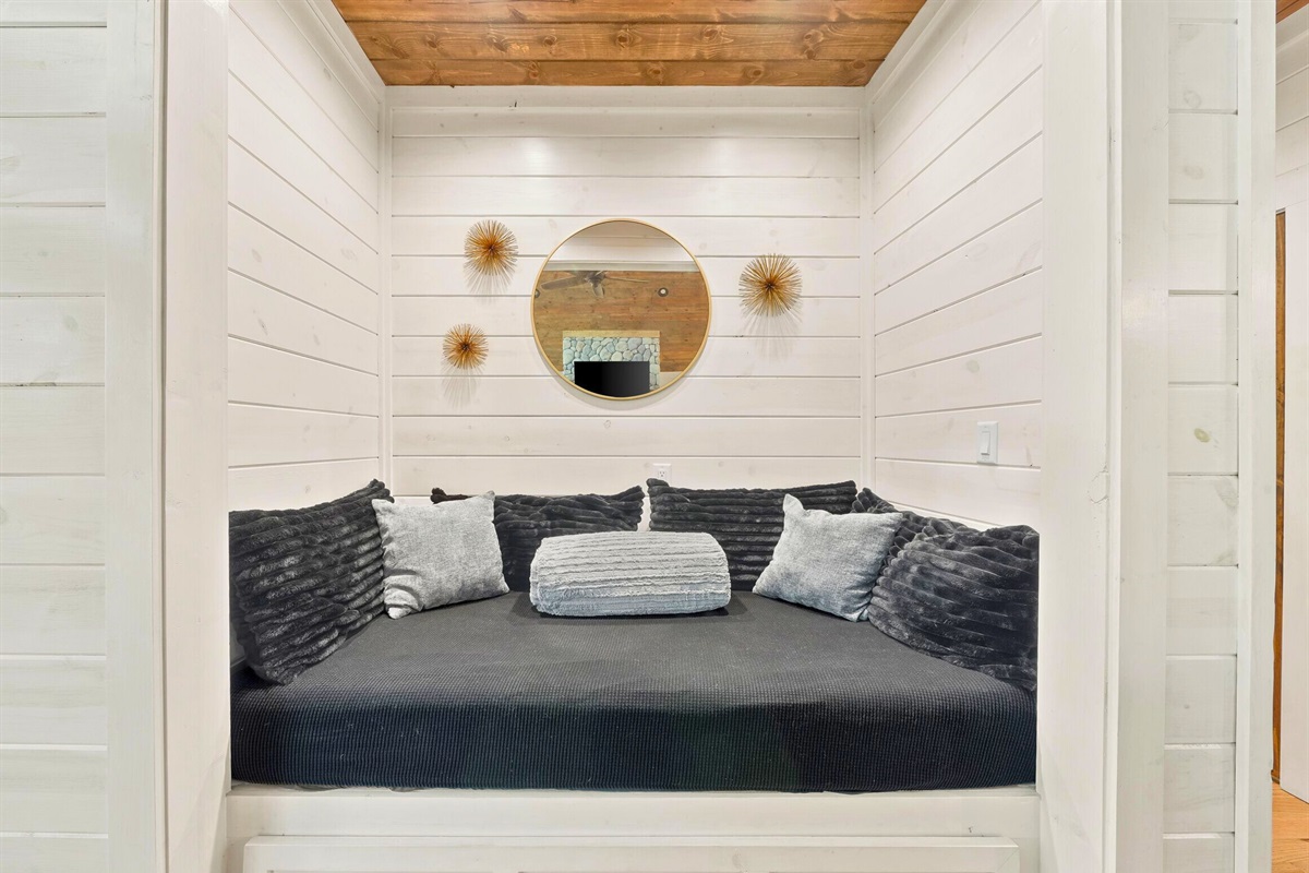 Bedroom with minimalist design and cozy bedding.