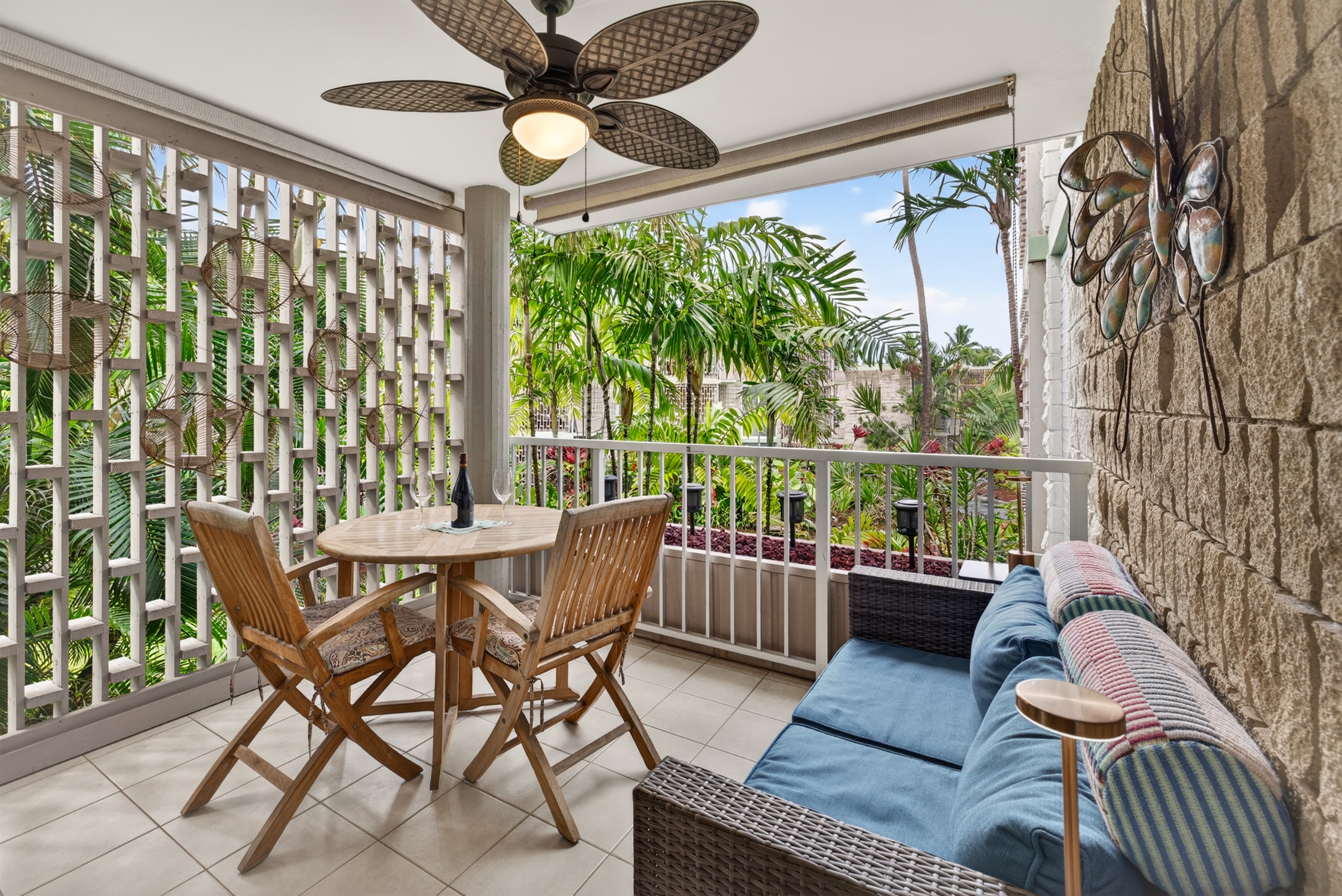 Spacious covered lanai with dining and lounge seating, overlooking the garden—perfect for relaxing, reading, or enjoying Kona’s warm evenings.