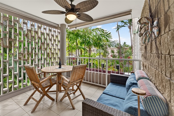 Spacious covered lanai with dining and lounge seating, overlooking the garden—perfect for relaxing, reading, or enjoying Kona’s warm evenings.