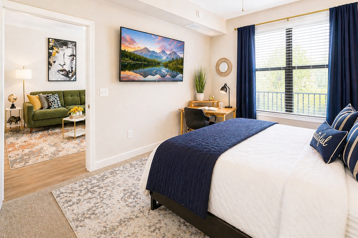 The bedroom sits off the living room with a door for privacy, blackout curtains for a good night's sleep, and its own Smart TV for watching your favorite shows from the comfort of bed. The bedroom overlooks the quiet, peaceful central courtyard.