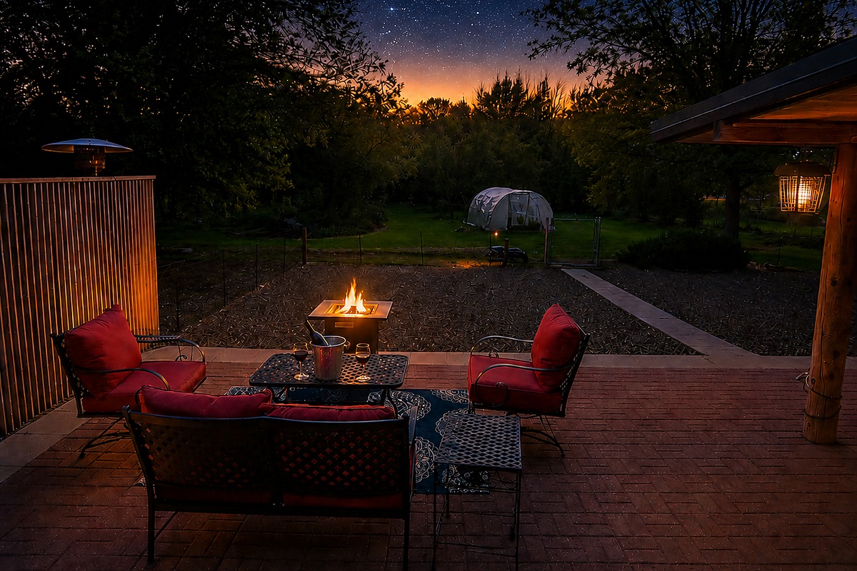 Outdoor seating - open night sky with a gas firepit, wine