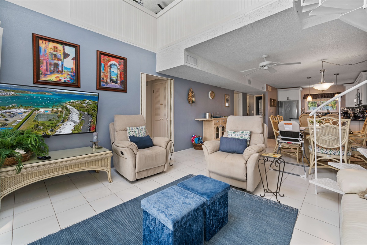 Comfortable living room with a spiral staircase leading up to the family loft space