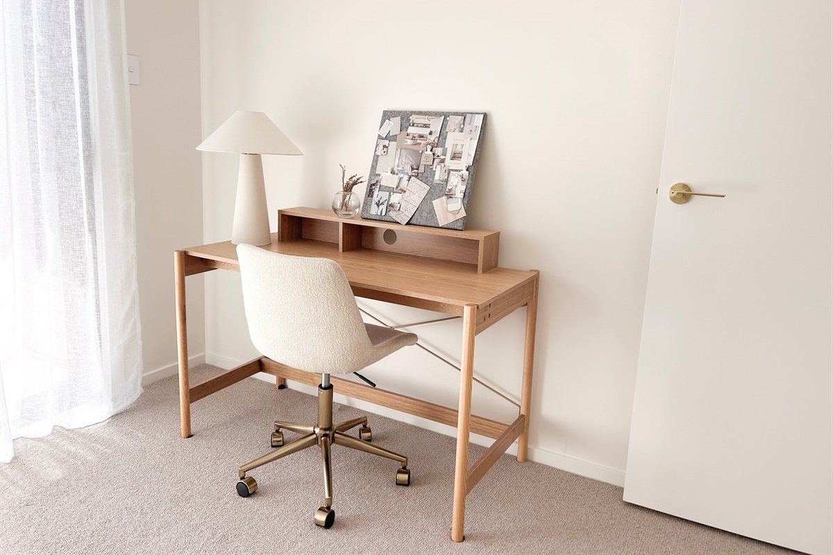 The dedicated workspace has a proper desk, chair and lamp, giving the fourth bedroom a useful study or laptop area.