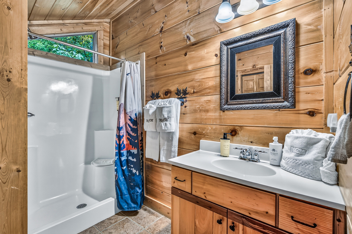 This well-designed bathroom combines rustic mountain decor with a convenient walk-in shower.