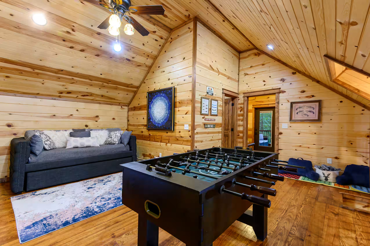 Game Room: Challenge friends to foosball amidst charming wood accents and inviting decor!