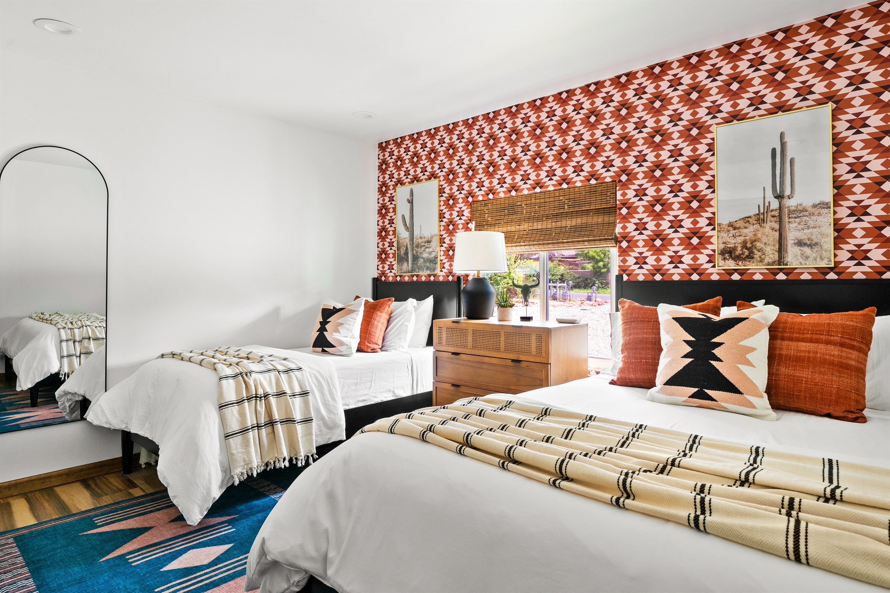Bright, southwestern bedroom with twin and queen beds, perfect to snuggle into after a day of hiking.