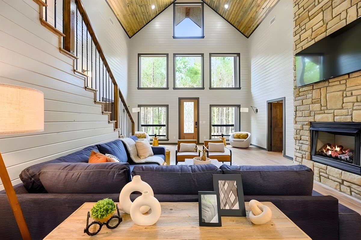 Natural light pours through the tall windows, highlighting the vaulted ceilings and creating a bright, welcoming space to unwind.