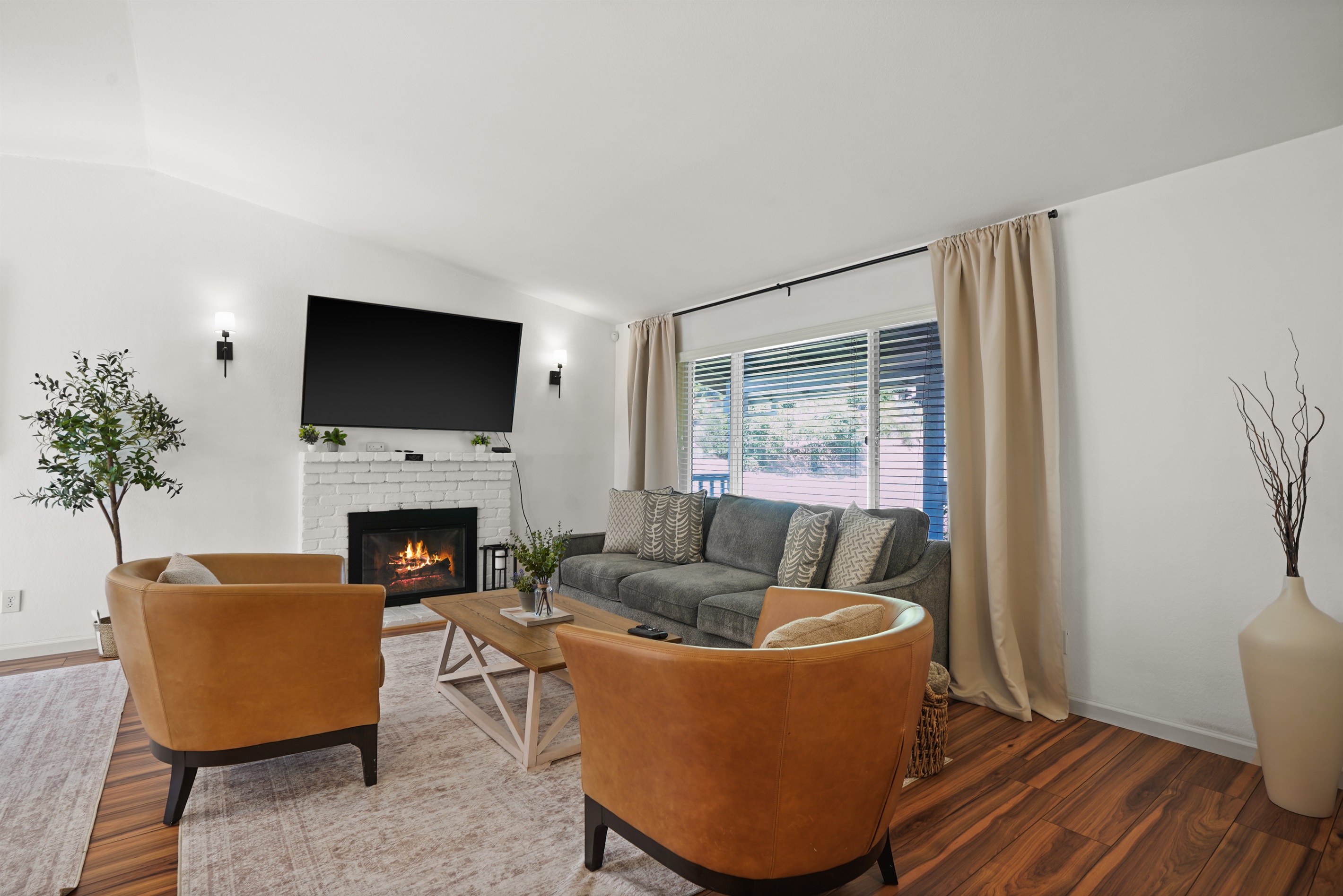 A living room that feels both elevated and effortless, with warm textures, natural light, and room to truly unwind.