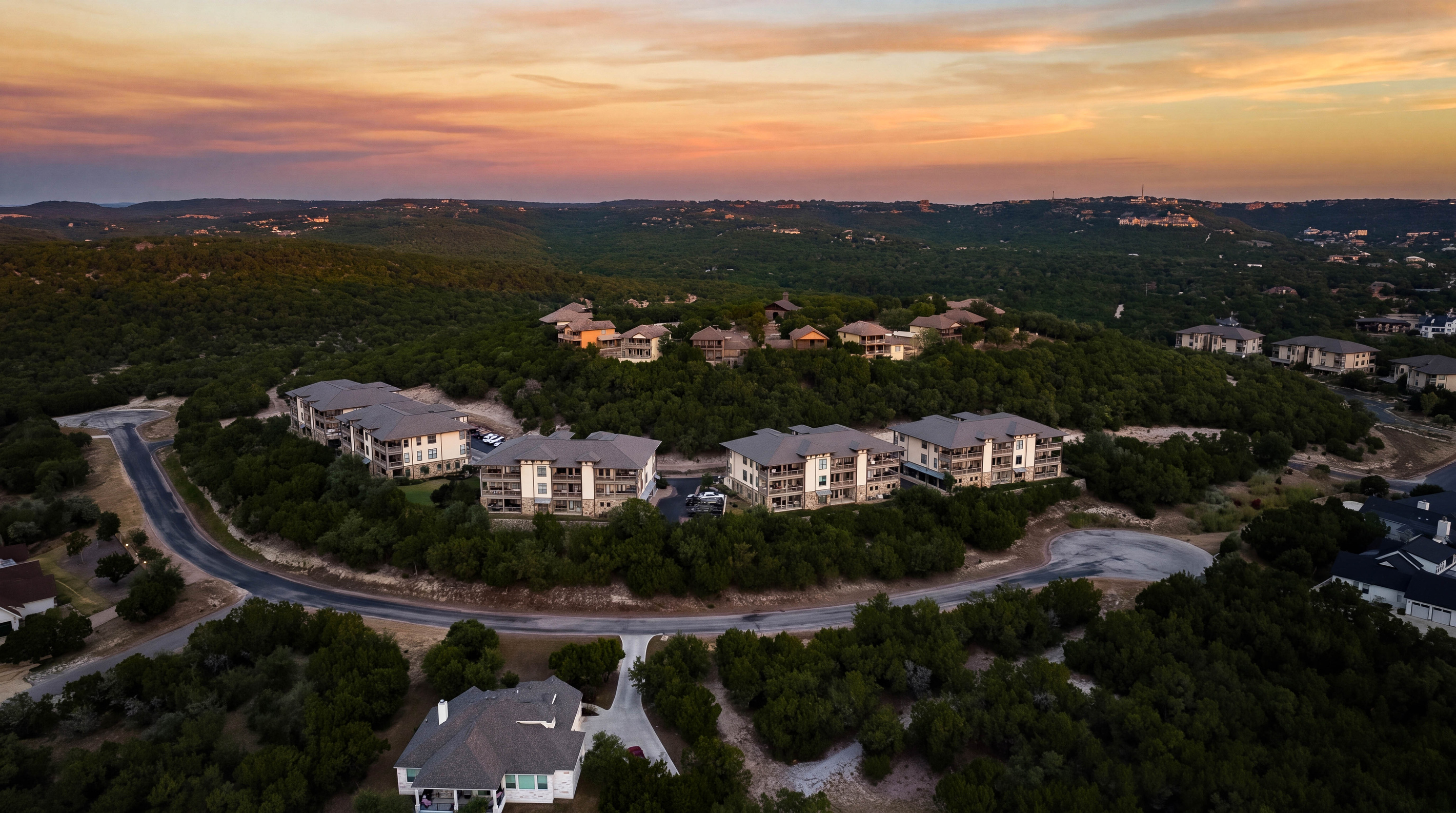 Hilltop condo community surrounded by the Texas Hill Country with Lake Travis just beyond.