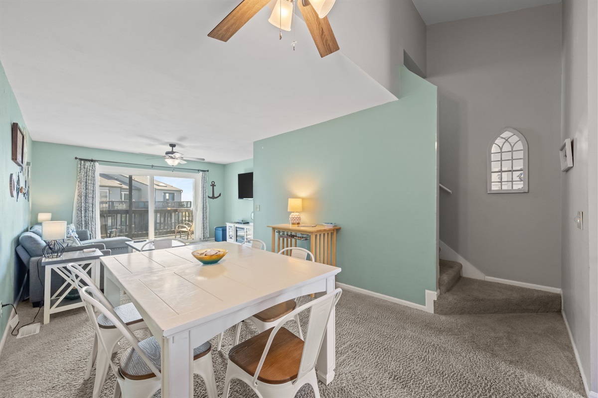 Gather around the dining table for meals, game nights, or planning the next beach day with the living room and balcony just steps away