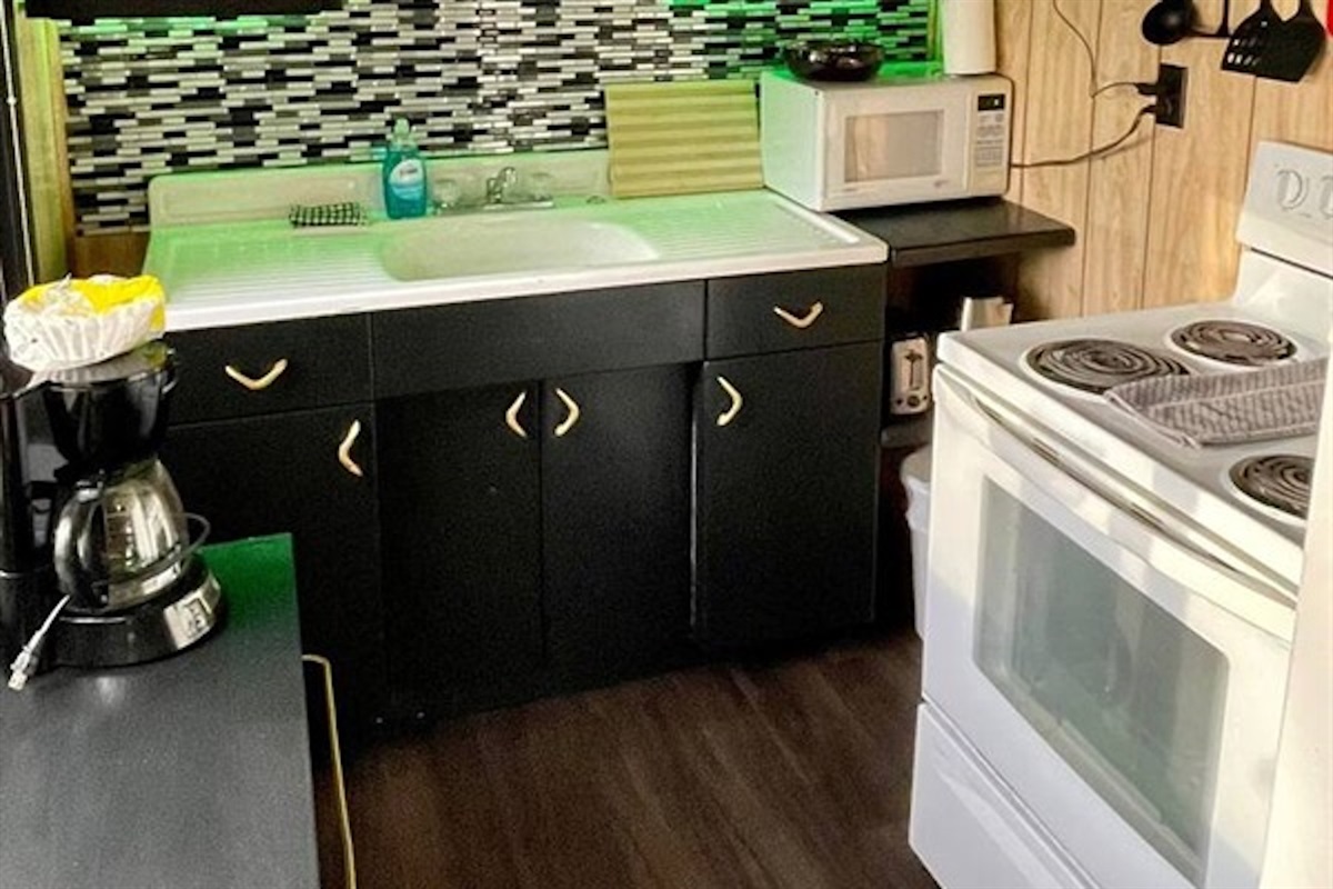 Fully equipped kitchen with stove, sink and counter space