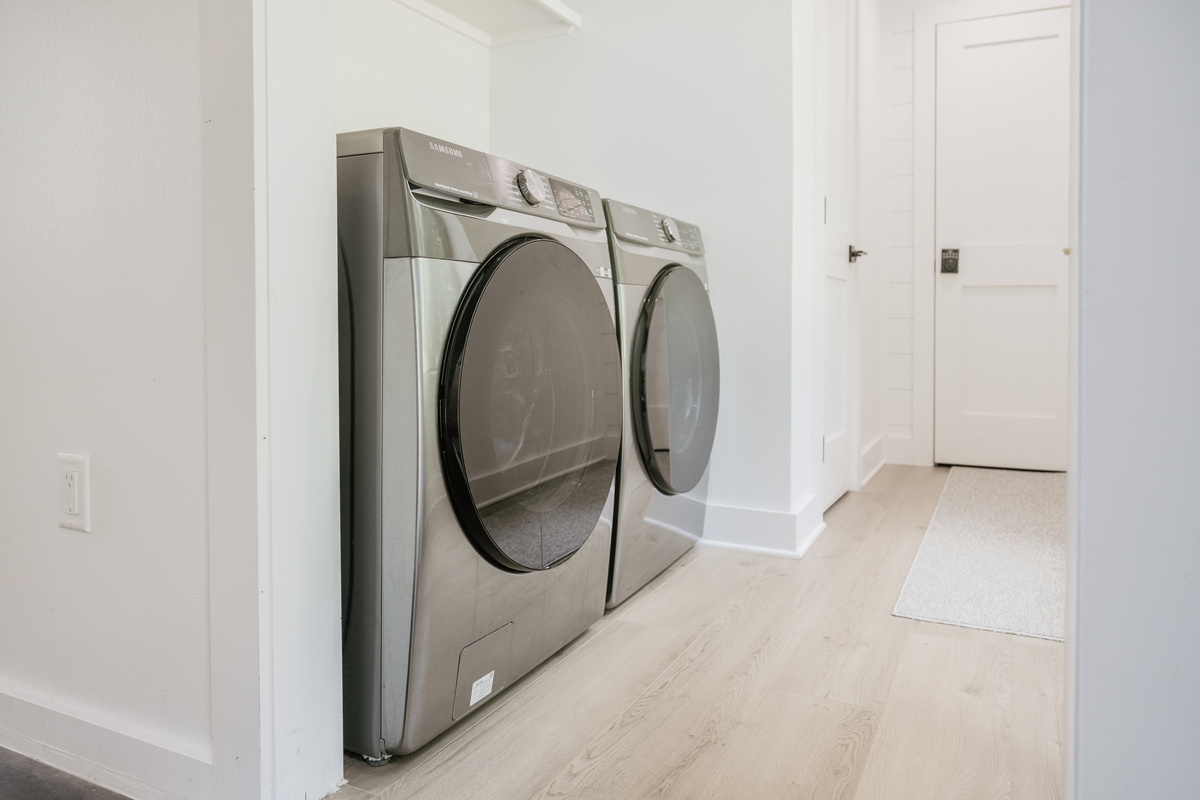 Full-size washer and dryer. Detergent pods are provided for your convenience.