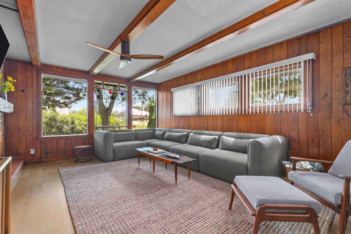 The living room features a large, comfortable sofa — the perfect spot to stretch out, relax, and enjoy time together.