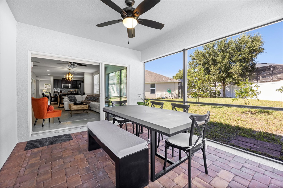 Enjoy open-air dining under the covered lanai — perfect for family meals or evening cocktails with a view of the backyard.