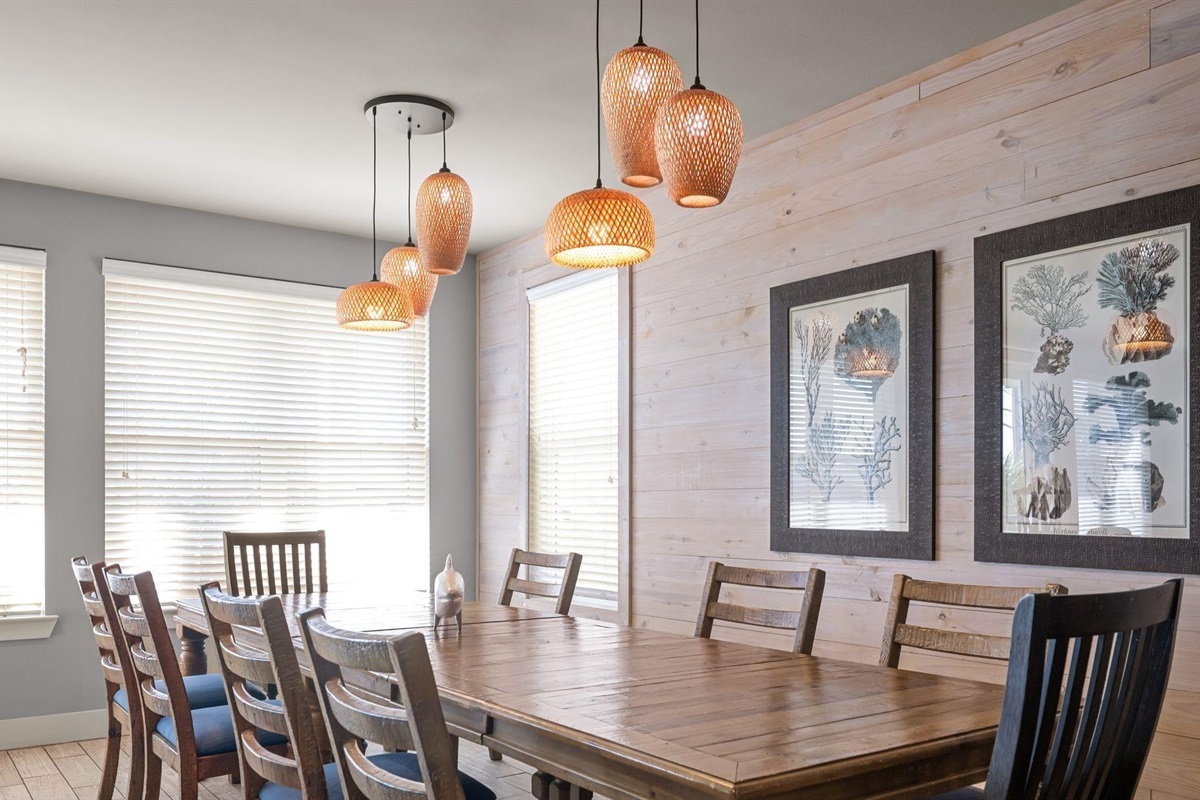Dining area with a table and chairs set for 8 and additional seating for 4 at the breakfast bar 