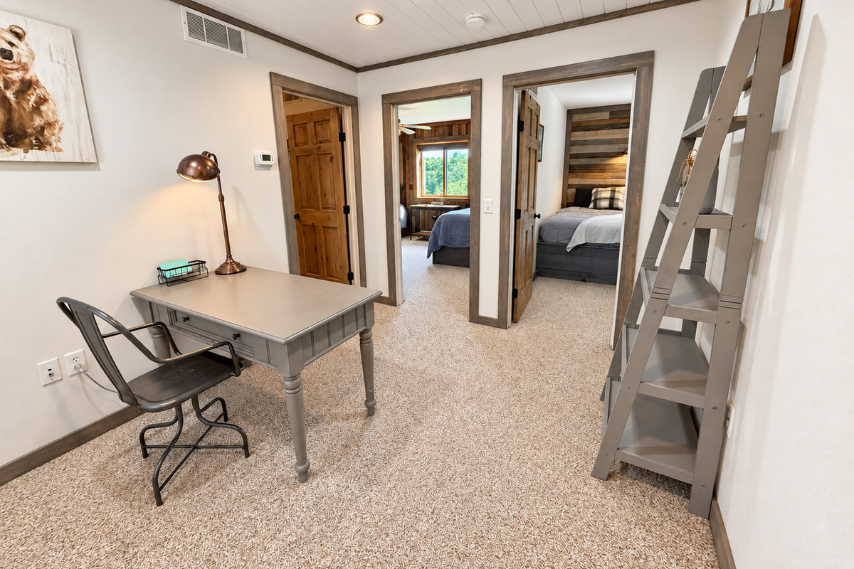 At the top of the stairs, this landing connects three private bedrooms and includes a handy desk/workspace—an easy, functional layout that gives your group convenient access to the upstairs sleeping areas.