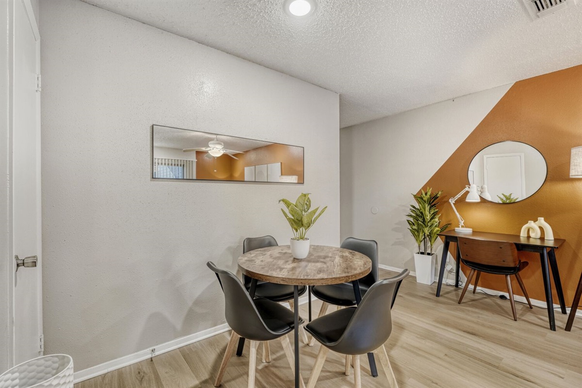 Stylish dining meets modern workspace in a warm, inviting setting.