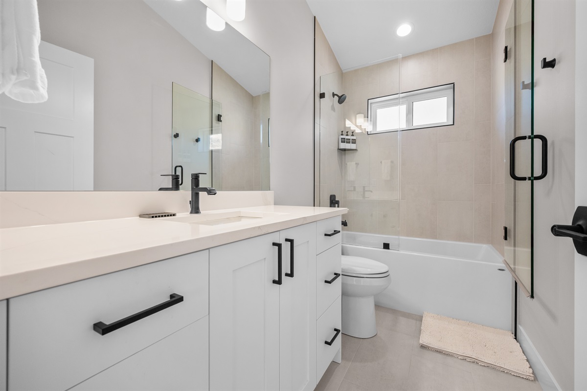 Main-Level Hall Bath with double vanity and tub/shower combo — perfect for families.
