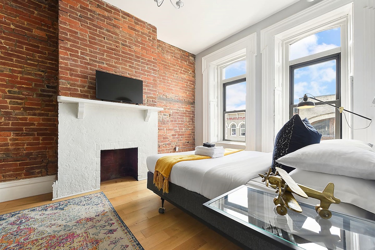 Spacious and elegant queen-sized bedroom with TV designed for comfort and style.