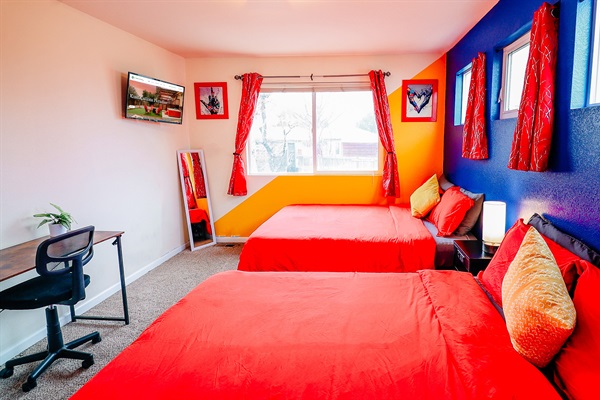 Dream in color! Our cozy haven features two queen-size retreats, a splash of bold red beds, and a workspace bathed in the calming hues of blue with a touch of sunshine yellow. 🛌💙🌞 #ColorfulDreamscape #CozyWorkspace